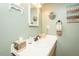 Well-lit bathroom featuring a vanity with a sink, decorative mirror, and wall decor at 304 Cornelia Dr, Graham, NC 27253