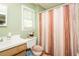 Bathroom with neutral walls, shower with curtain, and a vanity with storage at 304 Cornelia Dr, Graham, NC 27253