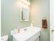 Bathroom featuring a white sink and vanity with a decorative mirror and soft lighting at 304 Cornelia Dr, Graham, NC 27253