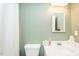 Bright bathroom features a white sink, toilet, and shower with white shower curtain at 304 Cornelia Dr, Graham, NC 27253