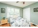 Cozy bedroom featuring hardwood floors, a ceiling fan, and a comfortable bed at 304 Cornelia Dr, Graham, NC 27253