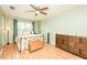 Bedroom with wood flooring, a charming metal bedframe, and a wood dresser at 304 Cornelia Dr, Graham, NC 27253