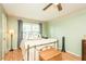 Bedroom with wood flooring, a charming metal bedframe, and a ceiling fan at 304 Cornelia Dr, Graham, NC 27253
