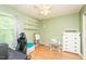 Bright bedroom featuring wood floors, white shelving, ceiling fan and an easel for creative fun at 304 Cornelia Dr, Graham, NC 27253