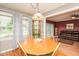 Dining room with wood floors, view of the front yard, and access to the living room at 304 Cornelia Dr, Graham, NC 27253