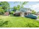 Charming two-story home boasts a lush lawn and a detached storage shed at 304 Cornelia Dr, Graham, NC 27253