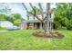 Well-maintained two-story home with solar panels and landscaped front yard featuring a large tree at 304 Cornelia Dr, Graham, NC 27253