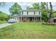 Charming two-story home with a well-manicured lawn, solar panels, and an American flag displayed at 304 Cornelia Dr, Graham, NC 27253