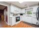 Clean kitchen featuring white cabinets, tile backsplash, modern appliances, and wood-look flooring at 304 Cornelia Dr, Graham, NC 27253