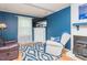 Inviting living room with blue walls, wood flooring, a comfortable recliner, and a fireplace at 304 Cornelia Dr, Graham, NC 27253