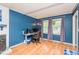 Comfortable office with blue walls, wood floors, a desk, and a window providing natural light at 304 Cornelia Dr, Graham, NC 27253
