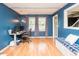 Cozy office space with blue walls, wood flooring, a built-in bench, and ample natural light at 304 Cornelia Dr, Graham, NC 27253