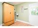 Cozy room with wood laminate flooring, a spacious wooden wardrobe, and a bright white door at 304 Cornelia Dr, Graham, NC 27253