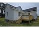Home exterior view featuring a new deck with wooden stairs, set against white vinyl siding at 305 E Harnett St, Benson, NC 27504