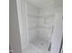 Modern bathroom shower featuring decorative marble tiling, a built in storage niche, and tiled floor at 305 E Harnett St, Benson, NC 27504