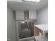 Modern bathroom showcasing sleek white cabinets, complemented by marble tiling and a skylight at 305 E Harnett St, Benson, NC 27504