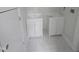 Bright bathroom with dual vanities featuring matching white cabinets and new tile flooring at 305 E Harnett St, Benson, NC 27504
