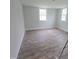 Bright bedroom with hardwood flooring and two windows creating a cozy and inviting space at 305 E Harnett St, Benson, NC 27504