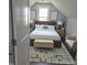 Charming bedroom with a cozy bed, accent chair, and stylish decor at 305 E Harnett St, Benson, NC 27504
