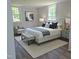 Comfortable bedroom with a king-size bed, soft lighting, and neutral color scheme at 305 E Harnett St, Benson, NC 27504