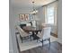 Elegant dining room featuring a round table, upholstered chairs, and contemporary chandelier at 305 E Harnett St, Benson, NC 27504