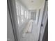 Inviting hallway with multiple windows allowing for natural light and tiled floors at 305 E Harnett St, Benson, NC 27504