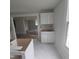 Open kitchen featuring white cabinetry, marble flooring, and an open design to the living area at 305 E Harnett St, Benson, NC 27504