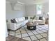 Bright living room featuring a white sectional sofa, modern rug, and stylish decor at 305 E Harnett St, Benson, NC 27504