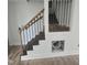 Elegant staircase featuring wooden steps and iron railings, adding a touch of sophistication to the home at 305 E Harnett St, Benson, NC 27504