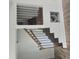 Interior view of a staircase featuring a blend of metal spindles and wood trim, complemented by wood floors at 305 E Harnett St, Benson, NC 27504