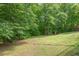 Enjoy the expansive backyard with mature trees for added privacy at 306 N Sixth St, Mebane, NC 27302