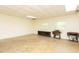 Spacious basement area with concrete floors, sewing machines, and two windows at 306 N Sixth St, Mebane, NC 27302