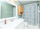 Neat bathroom with a white vanity, large mirror, and shower with a patterned curtain at 306 N Sixth St, Mebane, NC 27302