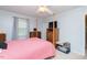 Bedroom featuring light walls, ceiling fan, and hardwood furniture at 306 N Sixth St, Mebane, NC 27302