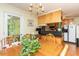 Eat-in kitchen featuring hardwood floors, and adjacent living room with stainless appliances at 306 N Sixth St, Mebane, NC 27302