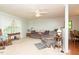 Comfortable living room with a large window, gray sectional, and a decorative ceiling fan at 306 N Sixth St, Mebane, NC 27302