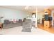 Inviting living room with neutral carpet, couch, chair, and view of the kitchen at 306 N Sixth St, Mebane, NC 27302