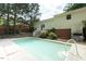 A refreshing in-ground pool is surrounded by trees and backyard greenery at 306 N Sixth St, Mebane, NC 27302