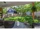 Well-maintained backyard showcases a lush lawn, fenced perimeter, and storage sheds at 308 Furches St, Raleigh, NC 27607