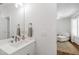 Bright bathroom with a modern vanity and sink, adjacent to a room with hardwood floors at 308 Furches St, Raleigh, NC 27607