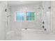 Bright bathroom with marble tiling, a glass shower enclosure, and dual windows at 308 Furches St, Raleigh, NC 27607