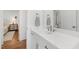 Modern bathroom with white vanity, chrome fixtures, and view of bedroom with neutral colors at 308 Furches St, Raleigh, NC 27607