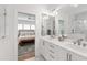 Bright, modern bathroom with double vanity, quartz countertops, and a view into the bedroom at 308 Furches St, Raleigh, NC 27607