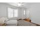 Light-filled bedroom with white walls and hardwood floors featuring a comfortable chaise lounge at 308 Furches St, Raleigh, NC 27607