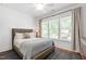 Inviting bedroom with large window, neutral tones, and warm-toned hardwood floors adding comfort at 308 Furches St, Raleigh, NC 27607