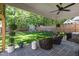 Covered patio includes outdoor seating and views of the lush backyard and shed at 308 Furches St, Raleigh, NC 27607