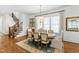 Dining room with a wooden table, elegant chairs and a staircase to the upper level at 308 Furches St, Raleigh, NC 27607