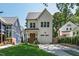 Charming white two-story home with manicured lawn and driveway, featuring a warm and inviting exterior at 308 Furches St, Raleigh, NC 27607