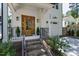 Inviting front porch with brick steps, black railings, and a beautiful wood front door at 308 Furches St, Raleigh, NC 27607