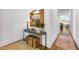 Bright hallway with hardwood floors, decorative console table, and view to the living area at 308 Furches St, Raleigh, NC 27607